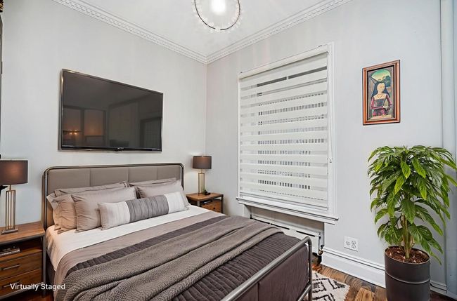 Bedroom featuring wood finished floors and ornamental molding | Image 29