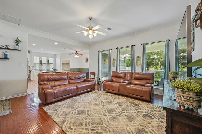 Living room featuring ceiling fan, ornamental molding, wood finished floors, and recessed lighting | Image 6