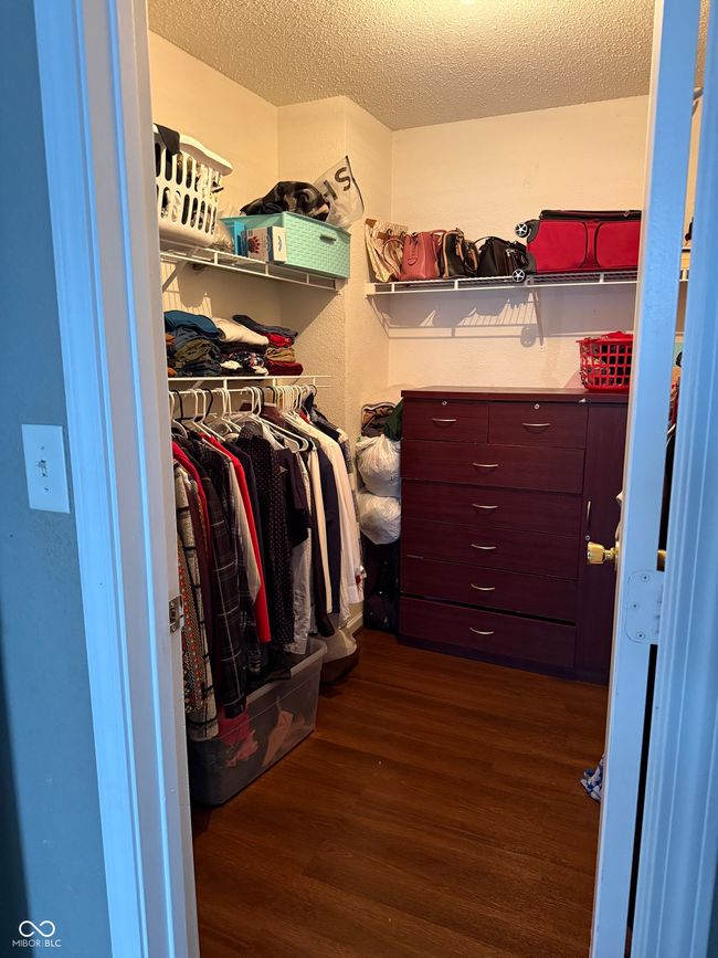 spacious closet featuring dark wood finished floors | Image 7