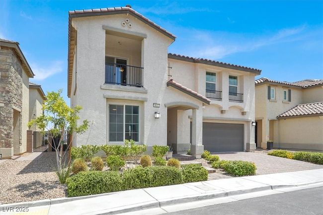 Mediterranean / spanish home with a balcony, stucco siding, a tile roof, and decorative driveway | Image 7