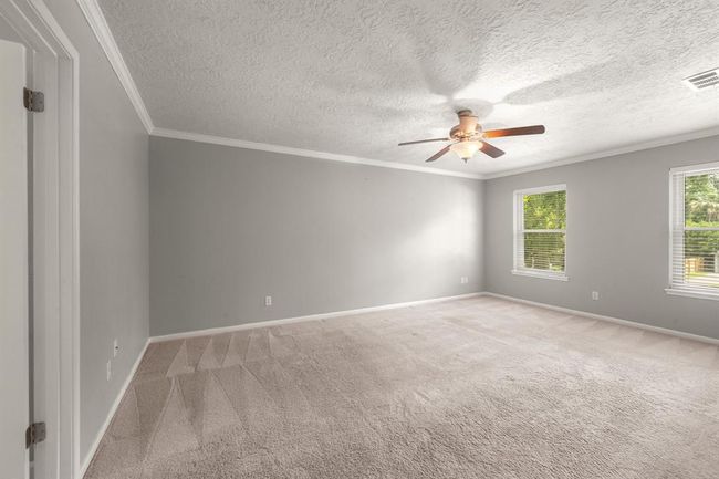 Spacious primary bedroom is located upstairs, keeping you close to the little ones while still offering a peaceful retreat of your own." | Image 24