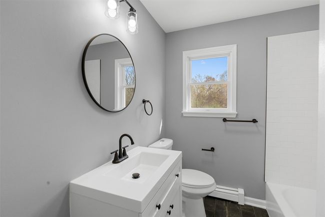 Full bath with toilet, baseboards, vanity, and a baseboard radiator | Image 17
