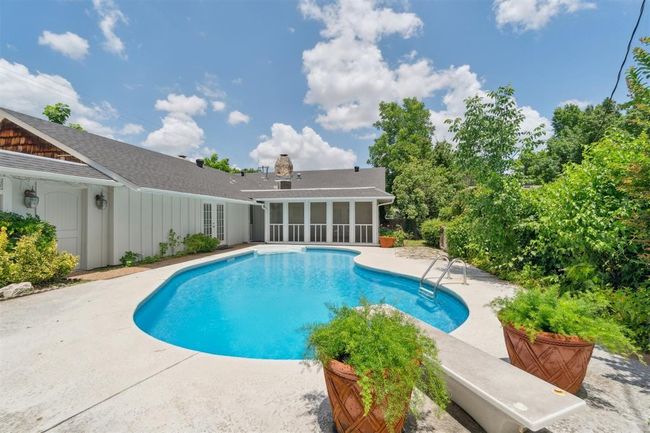 Swimming pool with a sunroom, a patio area, and french doors | Image 38