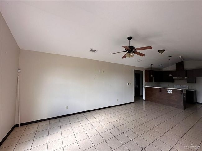 Unfurnished living room with light tile patterned flooring and ceiling fan | Image 5