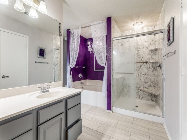 Bathroom with a garden tub, a shower stall, and vanity | Image 9
