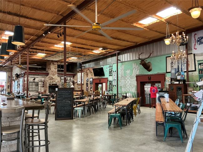 Dining room with concrete floors and a ceiling fan | Image 7