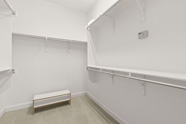 Spacious closet with light colored carpet | Image 21