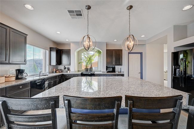 Kitchen View Featuring Granite Top Island and Countertops | Image 15