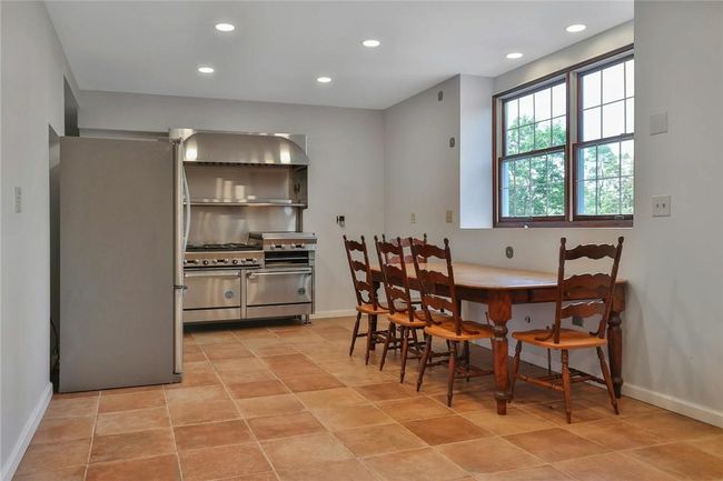 Freshly painted and appointed with new lighting and terracotta tile flooring | Image 11