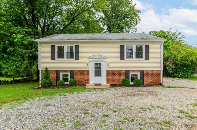 Split foyer home with a shingled roof, brick siding, and driveway | Image 34