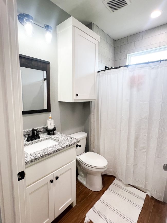 Bathroom featuring vanity, toilet, wood-type flooring, and curtained shower | Image 26