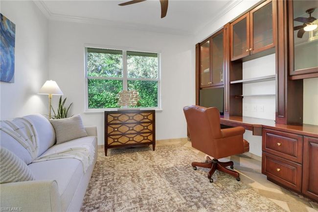Office featuring baseboards, ornamental molding, ceiling fan, and built in desk | Image 19
