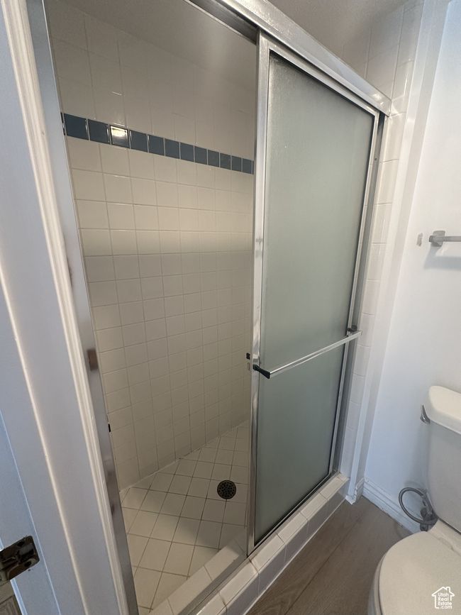 Full bathroom featuring a stall shower and wood finished floors | Image 6