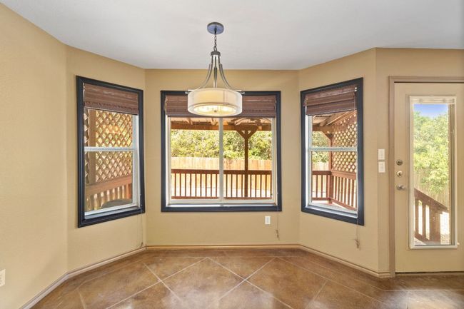 Unfurnished dining area with tile patterned flooring and baseboards | Image 15