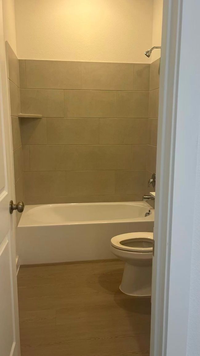 Bathroom with shower combination and light wood-style flooring | Image 5