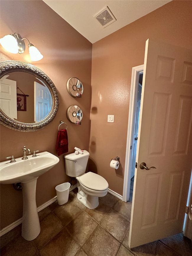 Half bathroom featuring baseboards, visible vents, and toilet | Image 10