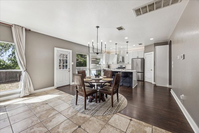 Dining area featuring baseboards, visible vents, recessed lighting, and a chandelier | Image 11