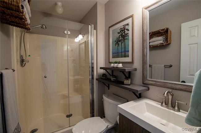 Full bathroom with toilet, a stall shower, and vanity | Image 16