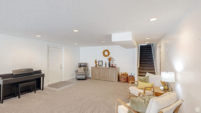 Sitting room with carpet floors, a textured ceiling, stairs, and recessed lighting | Image 25