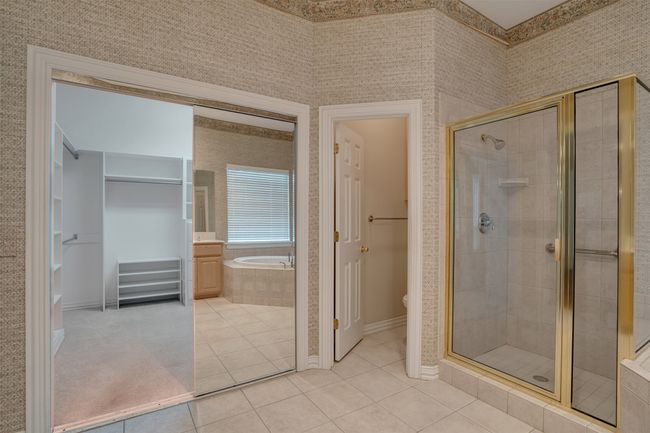 Full bathroom with a bath, tile patterned flooring, a shower stall, and baseboards | Image 21