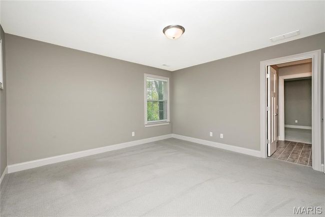 Upstairs bedroom featuring baseboards, light colored carpet, walk-in closet | Image 39