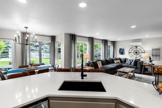Kitchen with open floor plan, healthy amount of natural light, a chandelier, a wall mounted air conditioner, and recessed lighting | Image 5