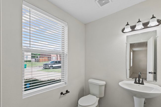 Bathroom featuring toilet and a sink | Image 11