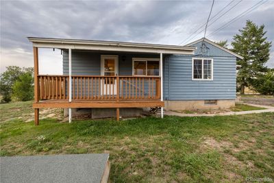 Cute front porch invites you into this cozy Ranch. | Image 2