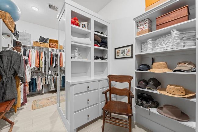 Oversized primary closet with hard surface flooring and storage. | Image 32