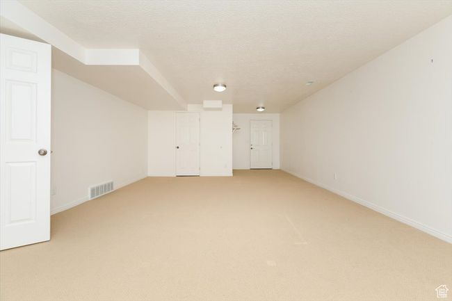 Bonus room featuring light colored carpet and a textured ceiling | Image 45