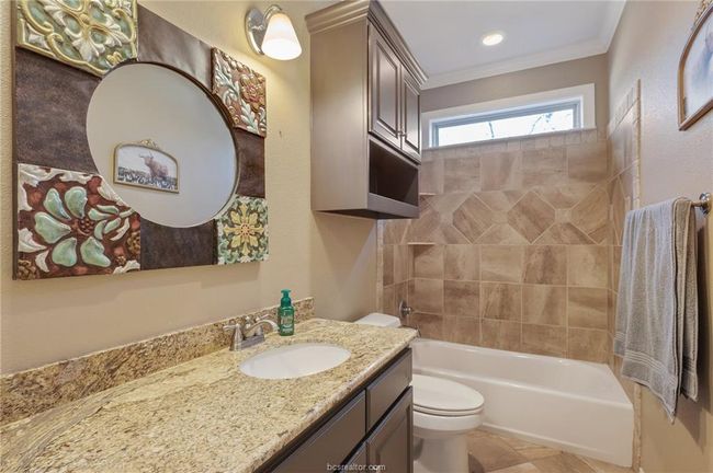 Full bathroom with vanity, shower / washtub combination, ornamental molding, and tile patterned flooring | Image 9