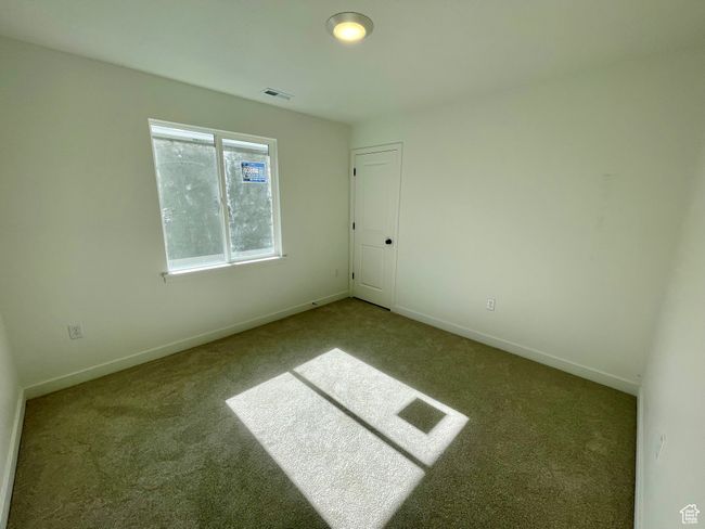 Carpeted empty room featuring baseboards | Image 18