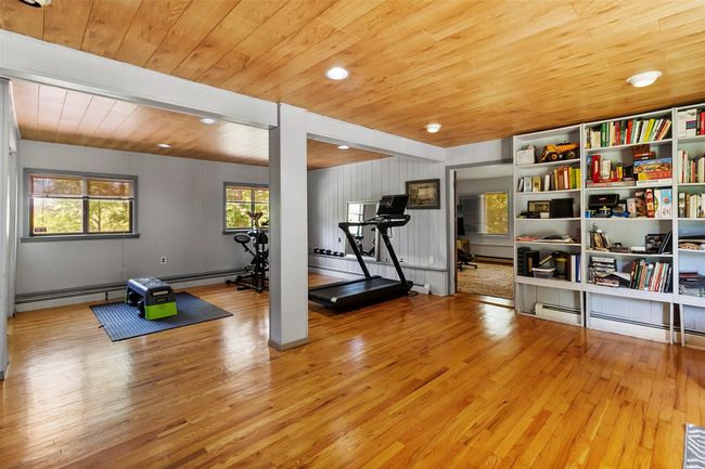 Workout area featuring wooden ceiling, hardwood / wood-style floors, a baseboard radiator, and recessed lighting | Image 13