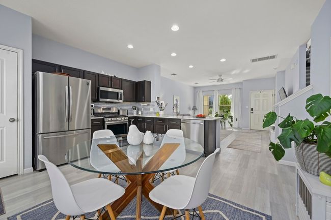 Dining space featuring a ceiling fan, light wood finished floors, visible vents, and recessed lighting | Image 21