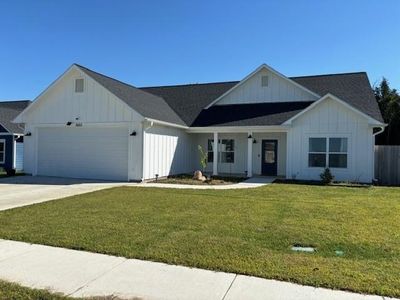 View of front of property with a garage and a front lawn | Image 1