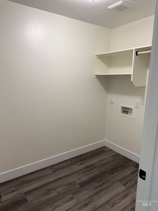 Laundry area featuring dark wood-style floors and washer hookup | Image 12