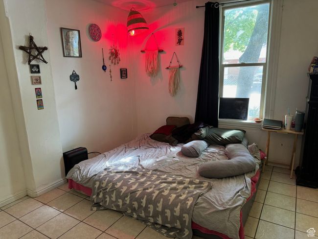 Bedroom with baseboards and light tile patterned floors | Image 6