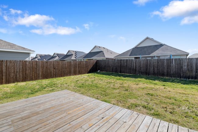 Wooden deck featuring a fenced backyard and a lawn | Image 21