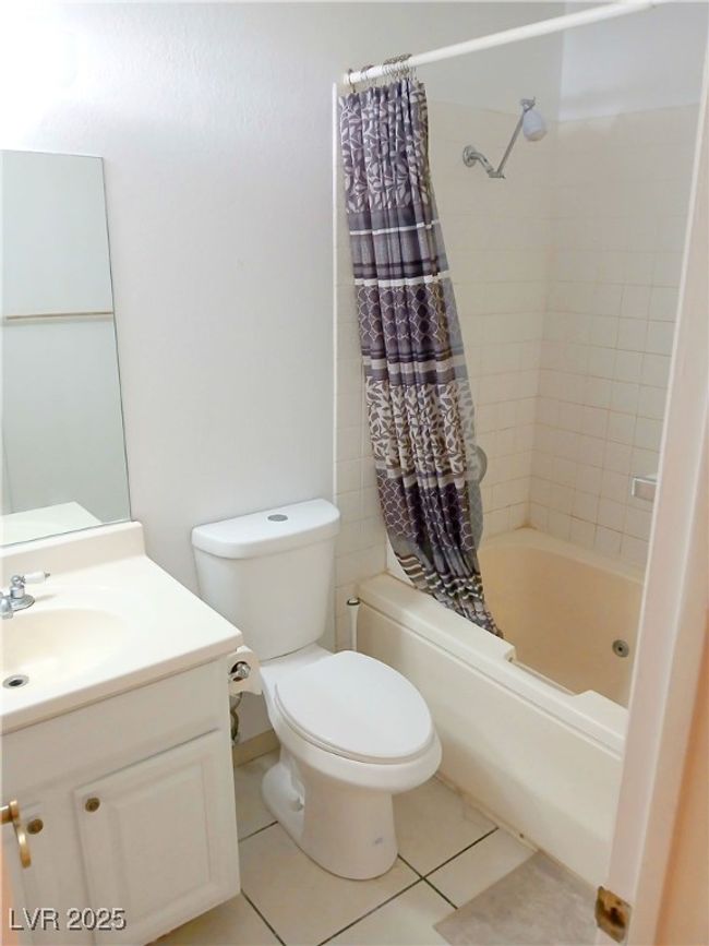 Bathroom with vanity, shower / bath combo, and tile patterned flooring | Image 8