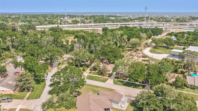 Aerial View of Neighborhood and where home is situated with treed lot behind it | Image 29