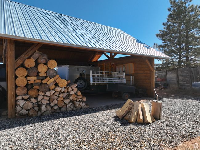 View of side of home with metal roof and fence | Image 11