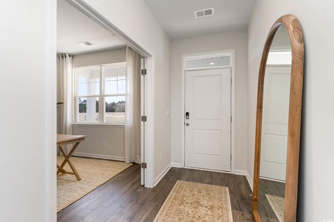 Entryway featuring baseboards, dark wood-type flooring, and visible vents | Image 6