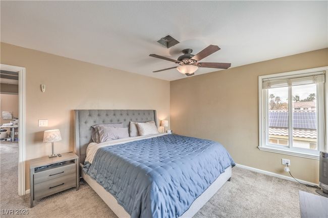 Bedroom featuring a ceiling fan, baseboards, and carpet floors | Image 26