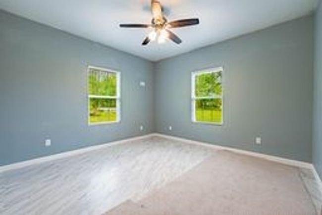 Empty room featuring a ceiling fan and baseboards | Image 5