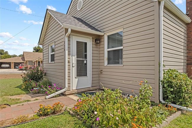 Doorway to property featuring a lawn | Image 7