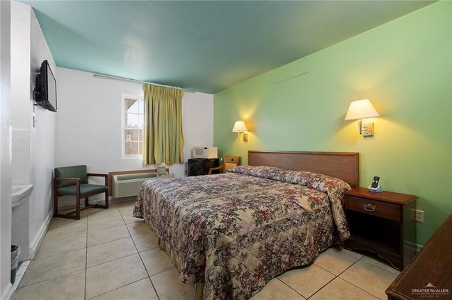 Bedroom featuring light tile patterned flooring and a wall mounted AC | Image 6