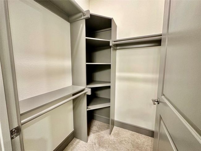 Walk in closet with light colored carpet | Image 4