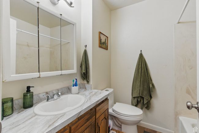 Full bathroom with vanity, toilet, a tub to relax in, and a shower | Image 10
