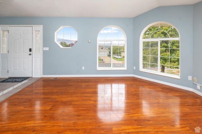 Entryway with vaulted ceiling, hardwood / wood-style floors, and a healthy amount of sunlight | Image 5