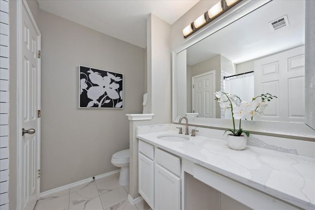 Bathroom featuring visible vents, toilet, marble finish floor, baseboards, and vanity | Image 19